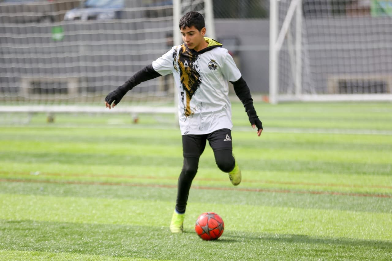 Player dribbling with an orange ball